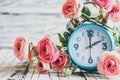 Daylight Savings Time with Clock and Pink Ranunculus Flowers Royalty Free Stock Photo