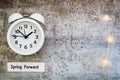 Daylight Savings Time Spring Forward concept top down view with white clock Royalty Free Stock Photo