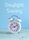 Daylight savings time white clock on a vintage aqua blue wood table Royalty Free Stock Photo