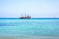 Daylight view from beachline to people watching two pirate ships Royalty Free Stock Photo