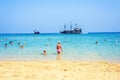 Daylight view from beachline to people watching two pirate ships Royalty Free Stock Photo