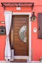 Daylight view to house entrance with wooden door Royalty Free Stock Photo