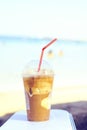 Daylight view to iced latte coffee drink near seashore Royalty Free Stock Photo