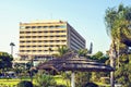 Daylight view to local hotel with sunchairs and trees Royalty Free Stock Photo