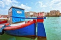 Daylight view to vibrant colorful blue and red boat parked in Venetian Lagoon Royalty Free Stock Photo