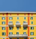 Daylight view to vibrant Mediterranean colorful yellow building facade in Milan, Lombardy, Italy.