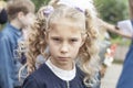 Daylight. a young girl with old hair and a backpack on her shoulders goes to school Royalty Free Stock Photo