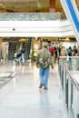 Daylighting roof structure with people walking and people movers Royalty Free Stock Photo