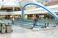 Daylighting roof structure with people walking and people movers Royalty Free Stock Photo