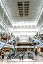 Daylighting roof structure with people walking and people movers Royalty Free Stock Photo