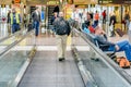 Daylighting roof structure with people walking and people movers Royalty Free Stock Photo