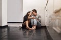 The days never wasted with love in it. an affectionate young couple sitting on the kitchen floor. Royalty Free Stock Photo