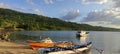 Daytime Beach View in Manado, with Mountains and Trees, Fishing Boats. Clear Blue Sky