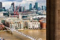 Daytime cityscape of London downtown with the tower of Tate modern museum on foreground and Thames river, Millennium bridge and