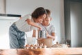 At daytime. Little boy and girl preparing Christmas cookies on the kitchen Royalty Free Stock Photo