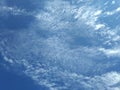The daytime sky is cloudy with streaks of clouds. Royalty Free Stock Photo