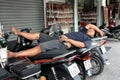 A man sleeps on motorcycles. Vietnam, Ho Chi Minh City