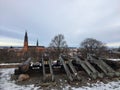Daytime view of metal cannons on the snow covered ground with the Uppsala Cathedral in the back Royalty Free Stock Photo