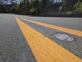 Daytime view of recessed solar road stud markers embedded in the center lane of an asphalted highway. Also known as a road Royalty Free Stock Photo