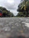 A daytime view of a tarmac road in Sri Lanka with heavy traffic.