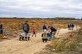 Families set out to pick pumpkins from a pumpkin patch on a chilly fall day Royalty Free Stock Photo