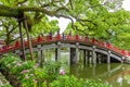 Tourists and local japanese people walk across the beautiful red bridge leading to the famous Tenmangu Shrine in Dazaifu, Japan Royalty Free Stock Photo