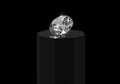 Dazzling diamond with reflection on black podium black background Royalty Free Stock Photo