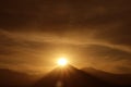 Dazzling Sun Rising on the Peak of Licancabur Volcano as Seen from the Town of San Pedro de Atacama in Northern Chile Royalty Free Stock Photo