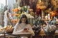 A dazzling, vibrant young woman shopping for New Year& x27;s decor and checking her smartphone. Royalty Free Stock Photo