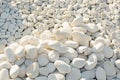 Dazzling white stones of different sizes, illuminated by the sun. Large and small Beach, mountains.. Autumn