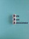 DBA acronym on wooden cubes with letters. Data Base Administrator or doing business as abbreviation DBA concept