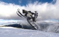 RIDER MAN WITH HELMET JUMPING WITH SNOWMOBILE BETWEEN CLOUDS ON WINTER Royalty Free Stock Photo