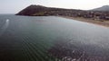 An aerial drone view of Bray Beach with Bray Head in the background with the emerald Irish sea and a speed boat in the distance Royalty Free Stock Photo