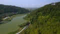 Aerial drone view of the Serayu River, the highway and railroad tracks on the side, with a background of hills, green pine forests Royalty Free Stock Photo