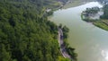 Aerial drone view of the Serayu River, the highway and railroad tracks on the side, with a background of hills, green pine forests Royalty Free Stock Photo