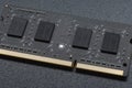 DDR SODIMM memory module. Close-up of an electronic circuit board with gold-plated contacts and memory chips