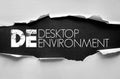 DE Desktop Environment text concept on torn paper background for software, operating systems, computer design, and user interface Royalty Free Stock Photo