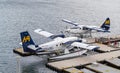 De Havilland Beaver float planes docked at Vancouver`s Harbour Airport in overcast day