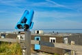 Blue telescope binoculars at beach on island texel, a popular travel destination for tourists in Europe Royalty Free Stock Photo