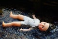 Dead doll floating in water Royalty Free Stock Photo