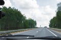 Dead insects on the windshield of the car. Flattened beetles on the surface of the glass