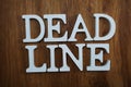 Dead line alphabet letters top view on wooden background