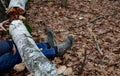 Dead man covered with a tree. the tree turned upside down and injured itself, falling while walking on a hiker, a forest worker. l Royalty Free Stock Photo