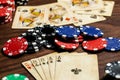 Dead Mans Hand against a pair of queens, vintage used cards and poker chips in blue, red, green and Black on a wood table with Royalty Free Stock Photo