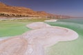 Dead Sea coastline with white salt and mountains in Ein Bokek, Israel