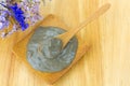 Dead Sea mineral mud clay mask from Israel in wooden spoon on wood background, top view . Royalty Free Stock Photo