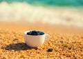 Dead sea mud in a cup on the beach Royalty Free Stock Photo