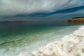 Dead Sea salt sediments against thunder sky Royalty Free Stock Photo