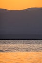 Dead Sea sunrise and mountains of Jordan in distance Royalty Free Stock Photo