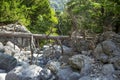 The dead tree lies across the bed of the dried river. at Samaria Gorge Crete, Greece. Royalty Free Stock Photo